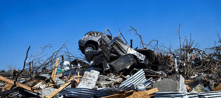 A car sits on top of a damaged house in Rolling Fork, Mississippi, after a tornado touched down in the area on March 26, 2023.
