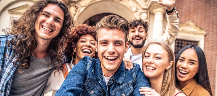 millennial best friends having fun taking group selfie portrait outside