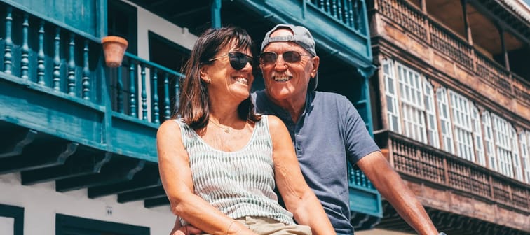 An older couple enjoy a sunny day outdoors.