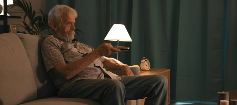 Bored retiree watching TV.