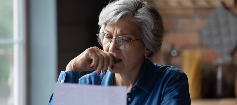 Distressed old age hispanic female check documents