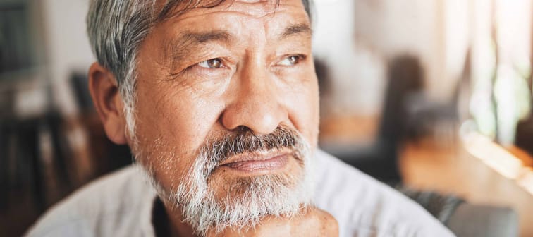 senior Asian man reflecting and relaxing at home