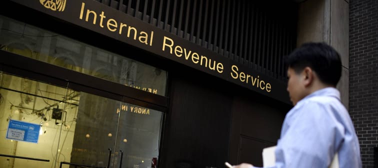 A Man Trying to File His Taxes Reads a Sign on a Recently Closed Internal Revenue Service Office Building in New York, New York USA