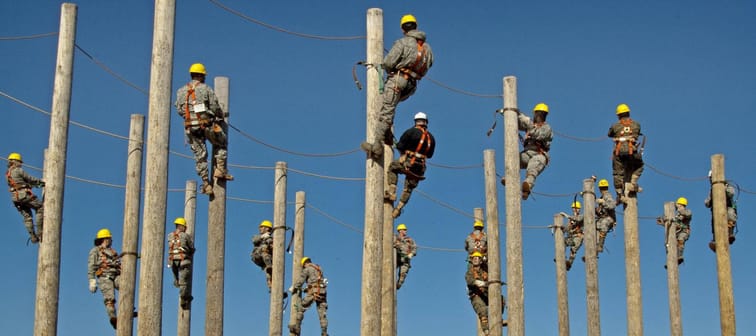 Workers in training on electrical poles