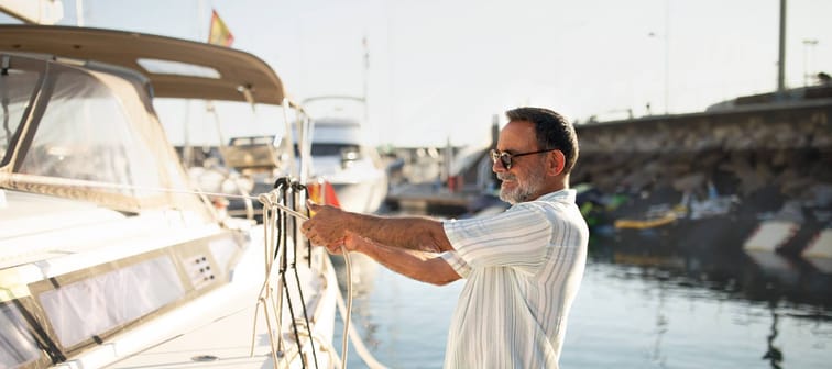 Man cleans yacht.