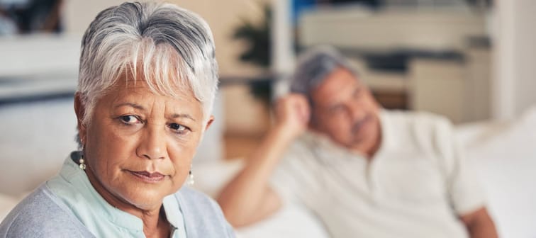 Frustrated senior couple, fight and divorce in conflict, argument or disagreement on living room couch.