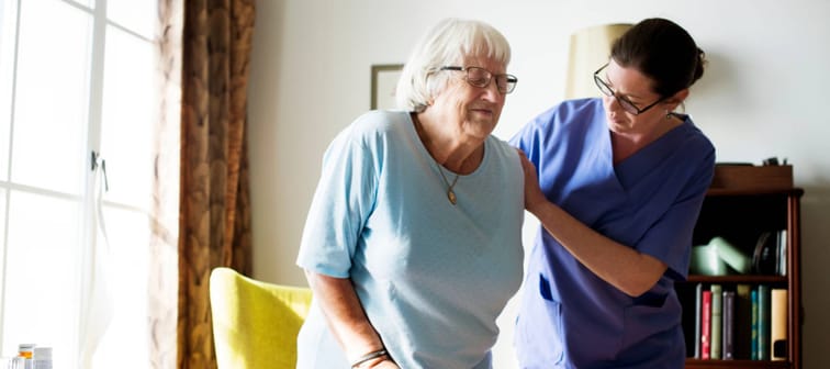 Nurse helping senior woman to stand