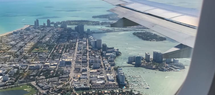 Image of Miami Beach seen from above through window of plane.