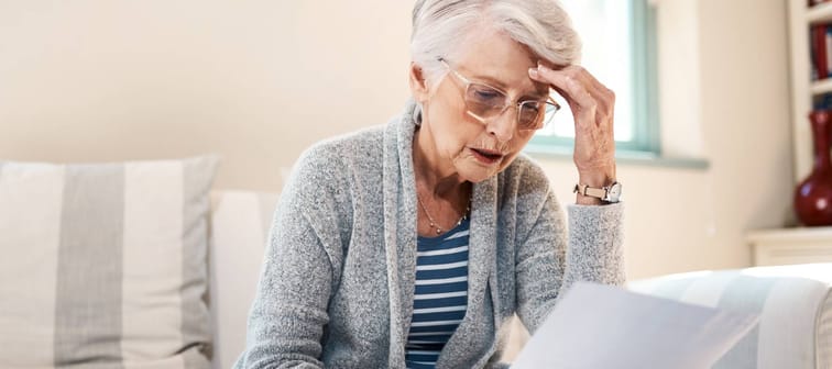 Senior women looking at paperwork with a worried expression