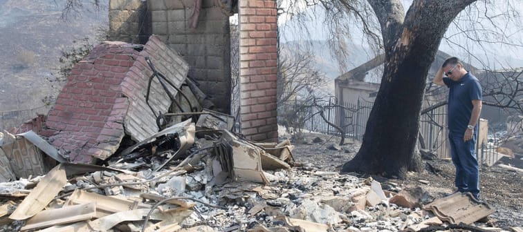 Man walks through wreckage after California fires