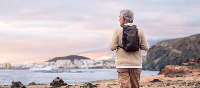 A man enjoying a hike by the coast alone.