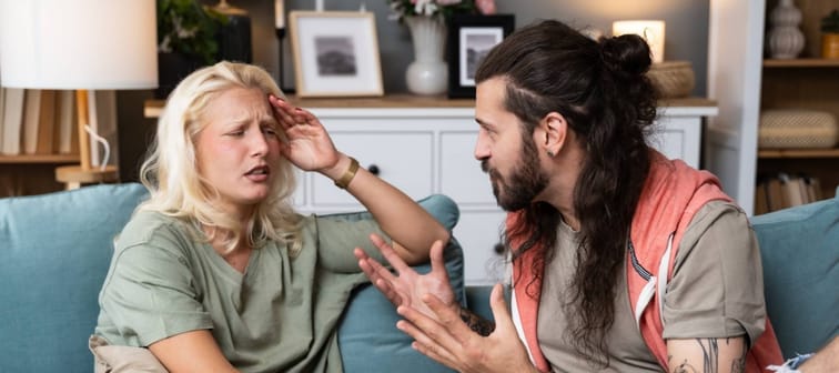 Young married couple husband and wife sitting at home having problems in their marriage