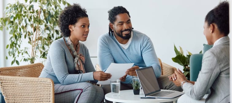 A couple talks to an adviser.