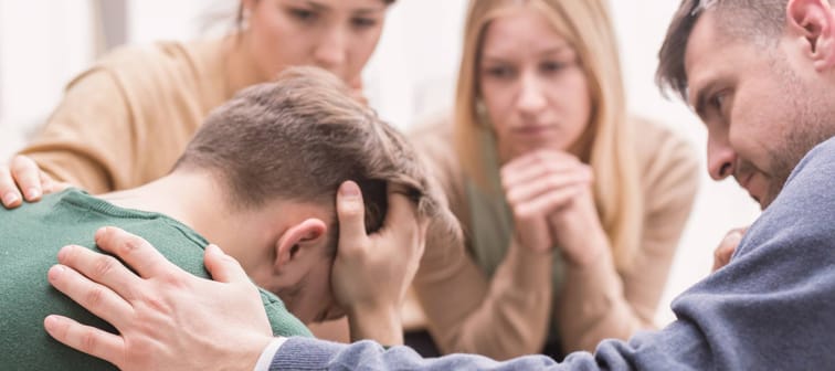 Devastated man with family