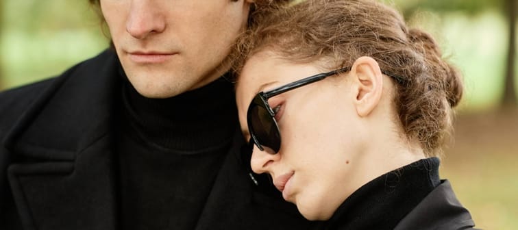 Close up of young woman leaning hand on husbands shoulder