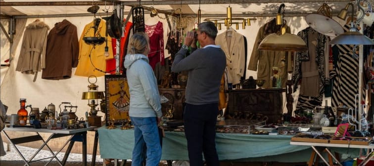 A senior couple at a flea market stand.