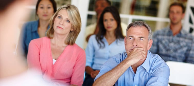 Group of people sitting listening to a speaker