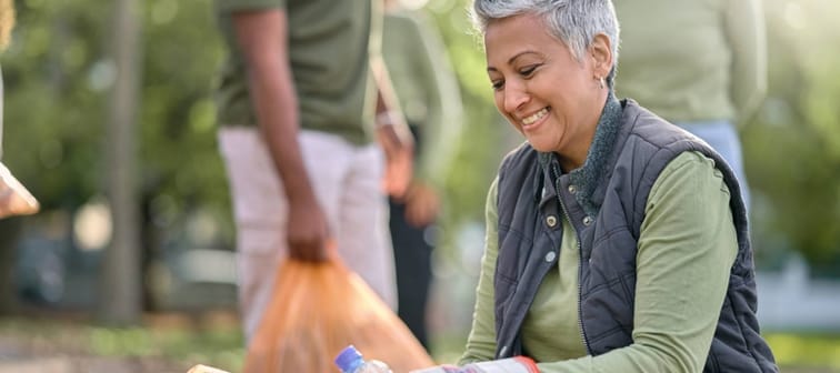 Senior woman picking up garbage.