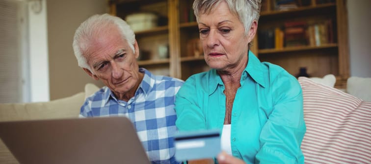 Couple looking at their credit card statements online