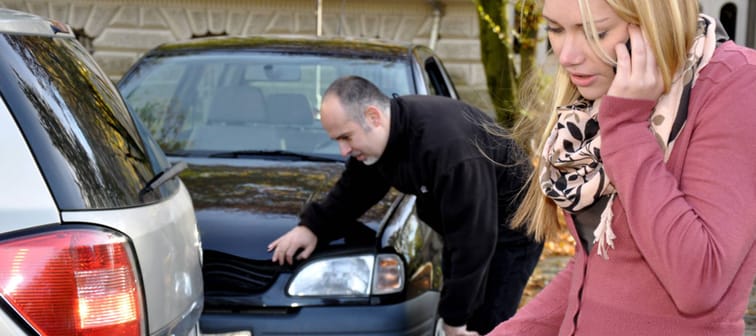 Woman calling police after car accident.