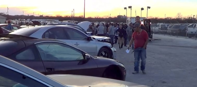 A group of people scope out a vehicle lot.