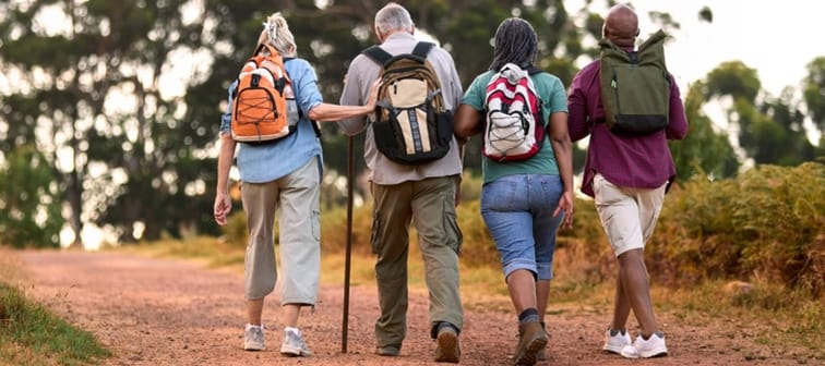 Four middle-aged people hiking.