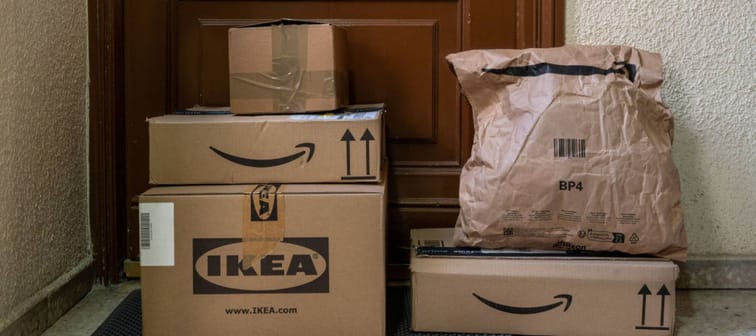 Amazon and Ikea delivery packages stacked at a front door.