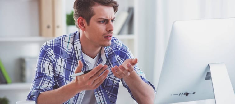Frustrated man looking at his computer