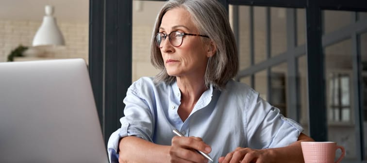 Woman at keyboard studying.