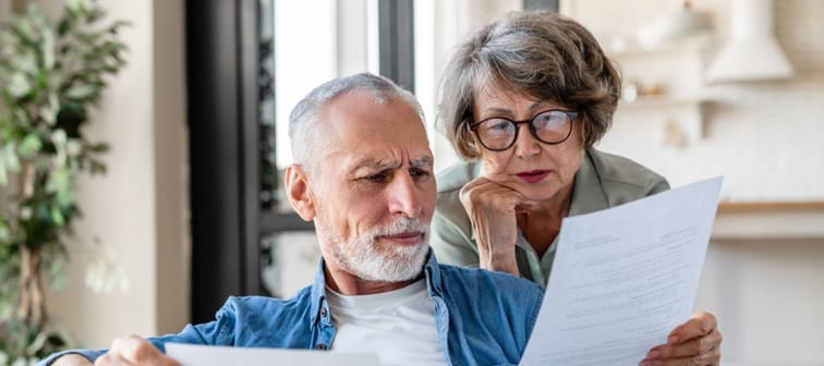 Senior old elderly spouses grandparents reading documents