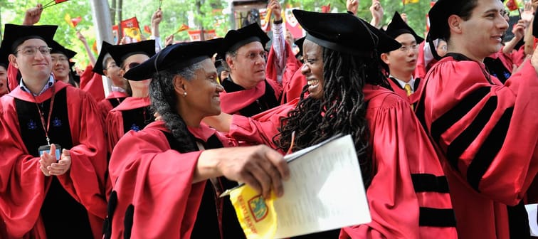 Two women hugging at a Harvard commencement.