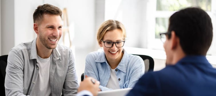 A young couple meeting with a financial advisor.