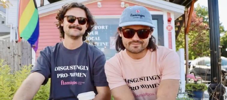 Two men wearing coffee shop merch
