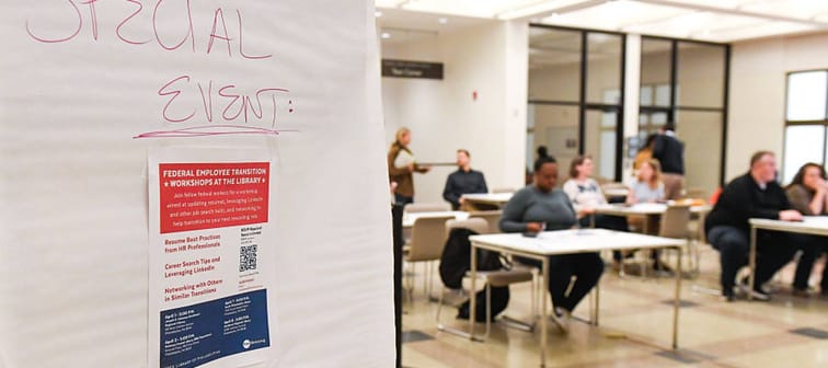 People sit at desks for an employment workshop.