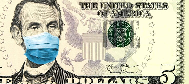 Coronavirus in United States. Concept for quarantine and recession.  5 dollar banknote with a face mask.