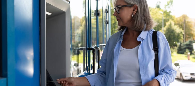 Middle aged woman at the ATM.