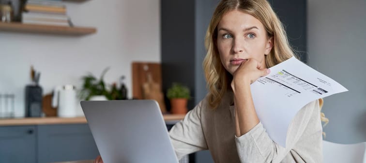 Woman concerned looking at her bills