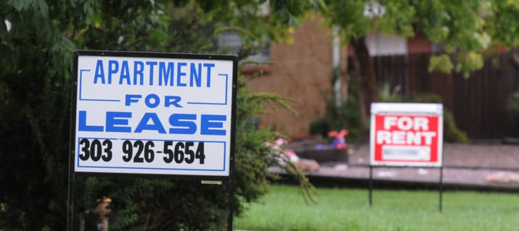 For rent signs on two adjacent lawns.