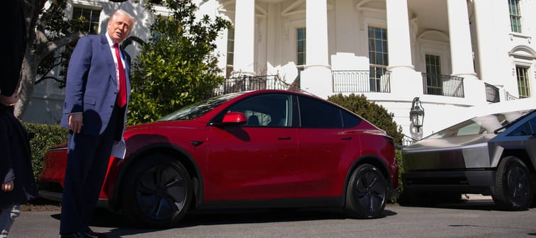 President Trump standing next to a Tesla