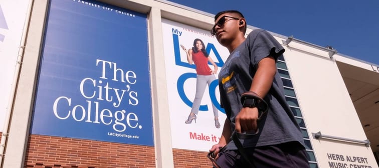 Young man walking by The City College in L.A.