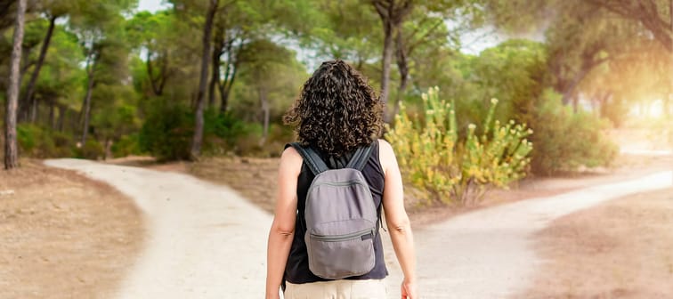 Woman in front of forking paths.