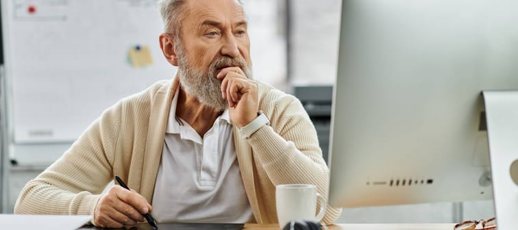 Senior man looking at his computer