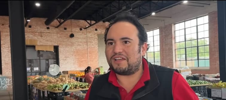 Arnie Perez talking to news reporter