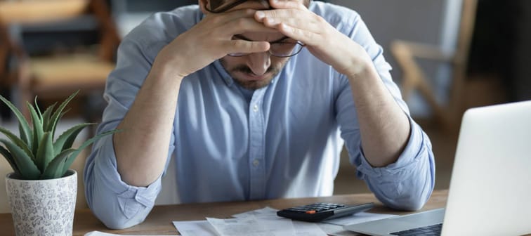 Man poring over stack of bills.