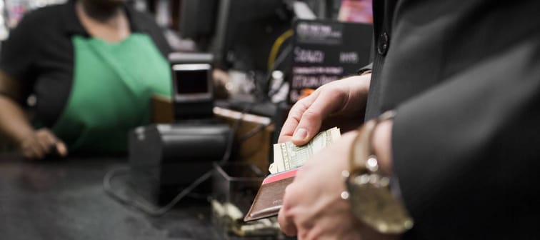 Man using cash to pay for items at the store