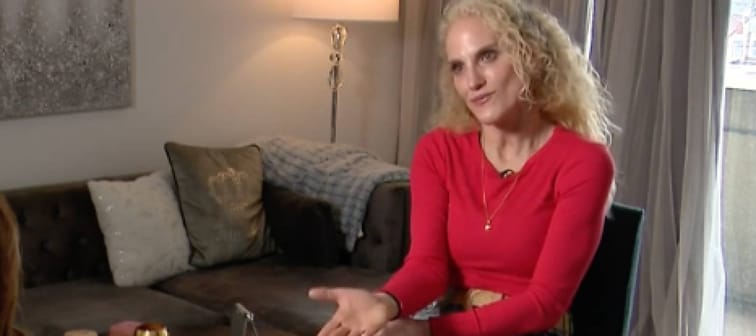 Woman talks to a reporter.