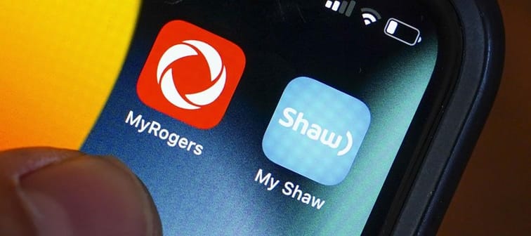 Rogers and Shaw applications are pictured on a cellphone in Ottawa on Monday, May 9, 2022. 