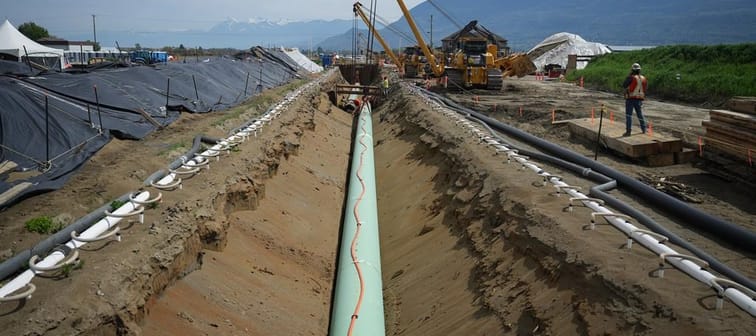 The Canada Energy Regulator has denied a request by Trans Mountain Corp. for a variance on a section of pipeline in B.C. Workers lay pipe during construction of the Trans Mountain pipeline ex