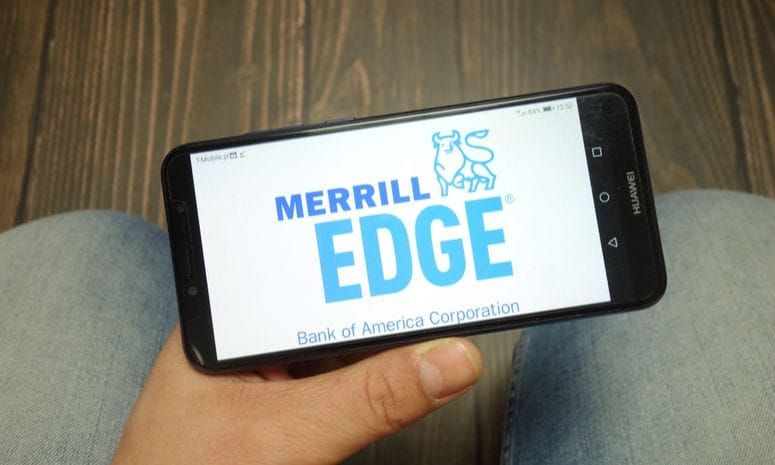 Merrill Edge trading platform logo displayed on Huawei smartphone