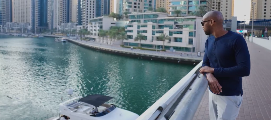 Jamal Robinson stands on a bridge looking out over the water in Dubai.